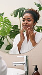 Skincare, mirror and woman with cream application for anti aging treatment, hyaluronic acid and natural beauty. Reflection, african person or cosmetics product for self care or face hydration in home