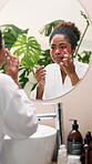 Skincare, eye patch and mirror with woman in bathroom for self care, glow and facial treatment. Cosmetics, grooming and collagen mask with person at home for dermatology, beauty and reflection