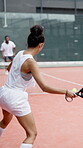 Athlete, girl and playing padel on court with match competition, serving ball and tournament game. Back, sport and player at fitness club for tennis practice, performance workout and agility outdoor
