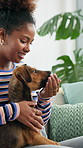 Home, dog and woman on sofa, smile and affection with weekend break, support and love. Apartment, pet and person with animal, best friends and bonding together with trust and happiness in living room