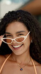 Face, smile and woman with sunglasses at resort for summer holiday, getaway trip and fashion. Portrait, happy and person laughing for funny joke, stylish swimwear and vacation travel at luxury hotel