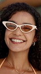 Face, happy and woman with sunglasses at resort for summer holiday, getaway trip and fashion. Portrait, smile and person laughing for funny joke, stylish swimwear and vacation travel at luxury hotel