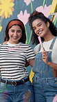 Women, smile and face with painting mural for flowers, art or project for community by wall. Girl, painter and friends with laugh with social responsibility, excited or volunteer by building in city