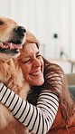 Golden retriever, girl and hug on sofa in home, smile or bonding in morning for love in living room. Woman, dog and pet animal on couch with embrace, touch or loyalty with care in lounge at apartment