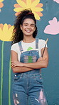 Happy woman, face and painter with confidence for art, design or colorful creativity at school. Portrait, female person or artist with smile, arms crossed or floral wall for mural activity or service