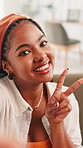 Face, woman and peace sign for selfie in home, smile and fun with live streaming vlog in living room. Portrait, profile picture and happy female gen z  with hand emoji and memory for social media