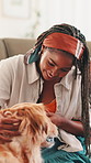 Home, woman and dog with treats for eating, companion and bonding together in living room. Sofa, animal and golden retriever with female person for feeding, snack and care for domestic pet in lounge