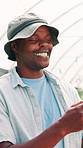 Greenhouse, agriculture and happy black man on farm for harvest results, laughing and typing. Smile, hothouse and. farmer with business for production idea, planning and thinking of agro with vision