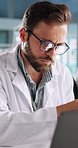 Medical, man and laptop in lab with tablet, research and smile for problem solving. Science engineer, tech and typing in office for result comparison, innovation or planning investigation with scroll