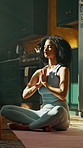Praying, meditation and woman in lotus pose in home for relax, zen or mental health in living room. Calm, inner peace and female person with yoga for mindfulness, energy or spiritual growth in house