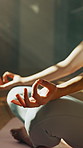 Hands, meditation and woman in lotus pose in home for relax, zen or mental health in living room. Calm, inner peace and female person with yoga for mindfulness, energy or spiritual growth in house.