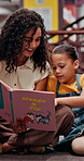 Woman, reading and child with book in library for knowledge, fantasy story and language development. Teacher, kid and novel for learning support, storytelling and literature information of education
