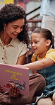 Smile, teacher and child with book in library for knowledge, fantasy story and language development. Woman, kid and help with creative novel for learning support, storytelling and reading information