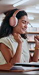 Headphones, library and woman student dancing with music, podcast and practice test. Education, college and female person study for assessment with audio, streaming or knowledge for assignment