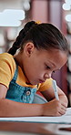 Girl, student and writing with book in library for school project, assignment or assessment. Child, kid or elementary learner with notebook or examination for drawing, motor skills or literature test