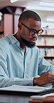 Black man, student and research with laptop at library for project, assessment or university assignment. Male person, academic learner or browsing with computer for literature paper, essay or thesis