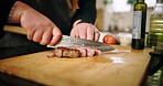 Cooking, hands and cutting steak in kitchen for dinner recipe, meal preparation and beef cuisine. Chef, person and meat protein on wood board for nutrition, healthy dining and food for lunch in home