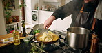 Hands, person and cooking pasta in kitchen with meal preparation, vegan diet and dining at house. Chef, mixing food and nutrition cuisine with healthy ingredients, gourmet recipe and culinary skills