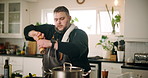 Man, chef and video in kitchen, recording and sauce pan with salt for flavor on cooking show in home. Person, tutorial and influencer with content creation, seasoning and streaming with meal in house
