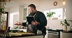 Man, home and frustrated in kitchen with tablet, doubt or confused as entrepreneur. Male person, issue and tech for tutorial question, research or recipe for private chef cooking or meal preparation