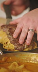 Cooking, hands and plating pasta with steak in kitchen for meal presentation, gourmet recipe or lunch service. Food, chef and cuisine ingredients in restaurant with beef protein, dinner or nutrition