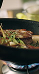 Recipe, hands and person with beef in frying pan for meal preparation, healthy dinner and sear meat cuisine in home. Closeup, chef and cooking steak with herbs for nutrition, protein food and lunch