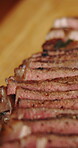 Steak, slice and closeup of food for meal prep, cooking and cuisine with fine dining or catering. Beef, nutrition and red meat dish on wooden board with culinary or gourmet protein for dinner