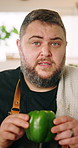 Talking, man and face of chef in home explaining pepper for meal tutorial, advice or recipe. Cooking, vegetable and portrait of man culinary artist with food tips for live streaming in house.