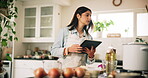 Cooking, food and tablet with woman in kitchen of home for preparation of meal or supper. Checking, reading and stove with chef person at counter in apartment for diet, healthy eating or nutrition