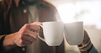Cheers, coffee and couple with mugs in home in morning for bonding, love and connection together. Relax, commitment and man with woman drinking cappuccino, latte or espresso for toast to marriage.