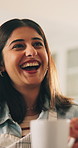 Woman, laughing and coffee with happiness for conversation, communication and beverage on break. Talking, chat and funny story with people in home together, discussion and humor on the weekend