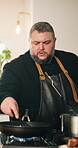Cooking, food and frying pan with man in kitchen of home for cuisine or meal preparation. Culinary, ingredients and stirring with chef person at stove in apartment for diet, health or nutrition
