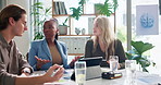 Meeting, talking and business people on tablet in office for finance review, budget analysis and statistics. Professional, teamwork and men and women on digital tech for research, planning or project