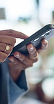 Hands, phone and texting at office with contact, click and check notification for deal at startup company. Person, smartphone and scroll on mobile app with chat, networking or social media at agency