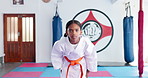 Bow, martial arts and self defense with face of girl in dojo for start of class, fight or lesson. Development, karate and serious with combat student in gym for exercise, fitness or sports training