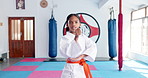 Girl, karate and ready with orange belt for martial arts training, self defense or fighting competition. Portrait, teenager or fighter preparation with strap or fist for taekwondo challenge in dojo