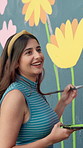Girl, painting and happy with mural on wall for flowers, art and design for community in urban town. Woman, painter and smile with social responsibility, creative and volunteer for building in Brazil