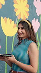 Woman, painting and happy with mural on wall for flowers, art and design for community in urban town. Girl, painter and talk with social responsibility, creative and volunteer for building in Mexico