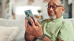 Phone, hands and senior man on sofa in home with communication, contact or social networking. Happy, cellphone and elderly male person reading online news on mobile app in living room at house.