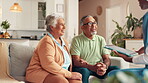 Elderly, couple and checkup with caregiver on tablet for good news, medical results and advice. People, nurse and talk with digital of healthcare information, diagnosis and explain treatment at house