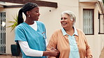 Outdoor, senior care and women with smile, nursing home and conversation with caregiver and laughing. Healthcare, nurse and funny joke for elderly patient, retirement and talking to old person