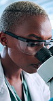 Black woman, scientist and forensics with microscope for research, medical study or discovery at laboratory. Female person, health worker or biologist with technology for microscopic examination