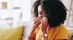 Home, tissue and woman with sneeze, cold and tired with allergy, hayfever and disease. Apartment, toilet paper and person on sofa, blowing nose or infection with symptoms, sick or pneumonia in lounge