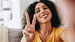 Selfie, peace sign and face of woman in home with relax, happiness or blowing kiss in living room. Smile, emoji and portrait of female person with photography for profile picture in apartment.