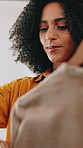 Shopping, fashion and woman in boutique with clothes for decision, choice or buying wardrobe. Retail, customer and female person at rack for outfit with discount, deal or sale at store in mall.