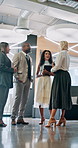 Talking, group and people in lobby for business, schedule update or plan in conference hall. Staff, project or keynote speaker with assistant in modern office for networking, seminar or career event
