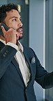 Man, phone call and discussion by window at office with networking, negotiation or contact at real estate agency. Person, realtor and smartphone with talking, feedback and deal for property investing