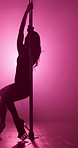 Woman, silhouette and pole dancer with stage light for private performance, VIP party and flexibility in club. Night, performer and sensual movement on floor for entertainment, spinning and burlesque
