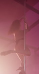 Woman, pole dance and flexible at club, balance or creativity with neon, art and performance at concert. Person, exotic dancer and legs for private show, stretching and fantasy on stage with smoke