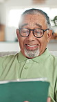 Senior, happy man and sofa with tablet for online entertainment, word search or game at home. Elderly, male person or pensioner with smile or glasses on technology for fun subscription or connection